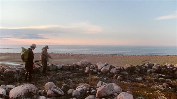 Original caption (Canadian Press): Johnny Mamgark, of Arviat, right, points out stone structures on Hubbard Point to Chris Debicki, of Oceans North Canada, last summer. 