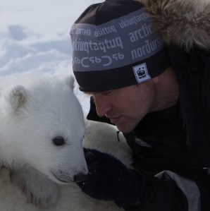 Figure 1. Biologist Jon Aars with a Svalbard cub.  